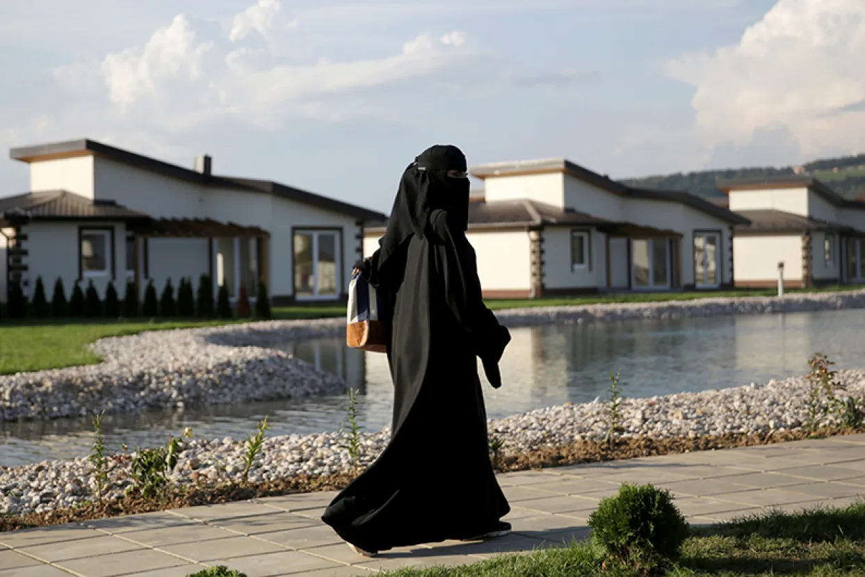 A tourist from the Middle East walks through Sarajevo Resort in Osenik near Sarajevo, Bosnia and Herzegovina, August 10, 2016. Picture taken August 10, 2016. REUTERS/Dado Ruvic