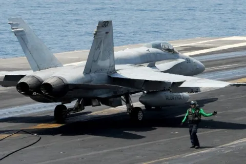 140830-N-MU440-025 ARABIAN GULF (Aug. 30, 2014) An F/A-18C Hornet assigned to the Valions of Strike Fighter Squadron (VFA) 15 moves across the flight deck of the aircraft carrier USS George H.W. Bush (CVN 77). George H.W. Bush is supporting maritime security operations and theater security cooperation efforts in the U.S. 5th Fleet area of responsibility. (U.S. Navy photo by Mass Communication Specialist 3rd Class Lorelei Vander Griend/Released)